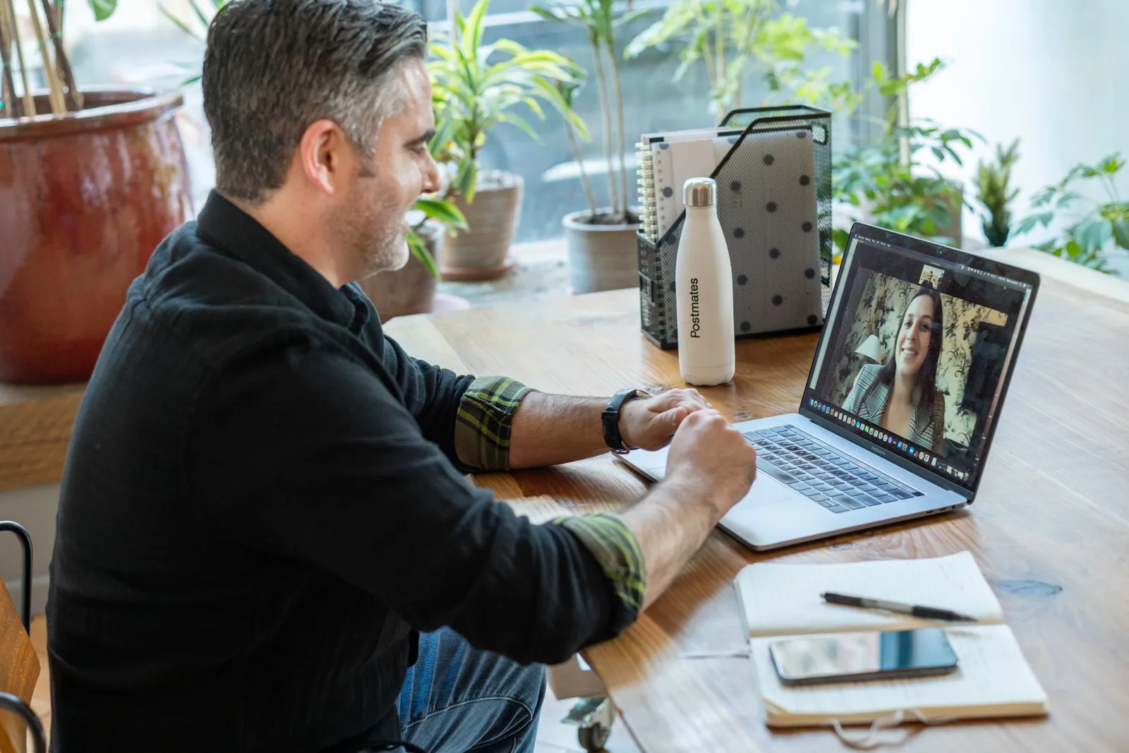 A coach reviewing progress charts with a client on screen