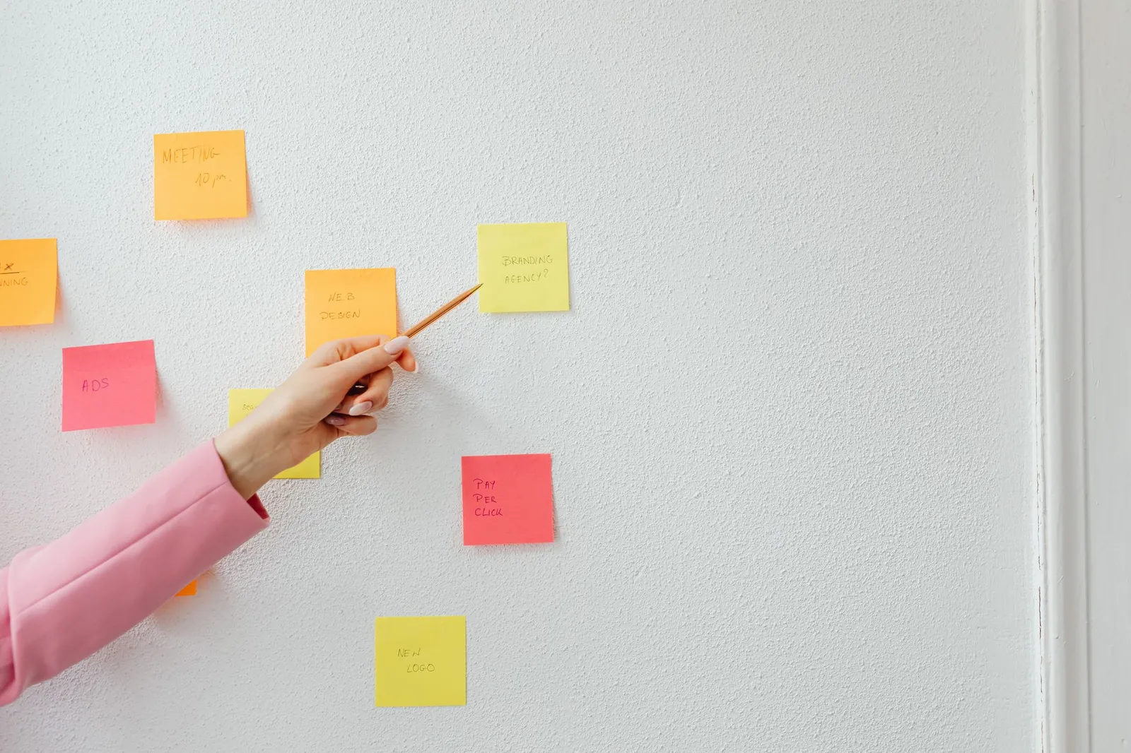 A person mapping a process out on paper beside a laptop