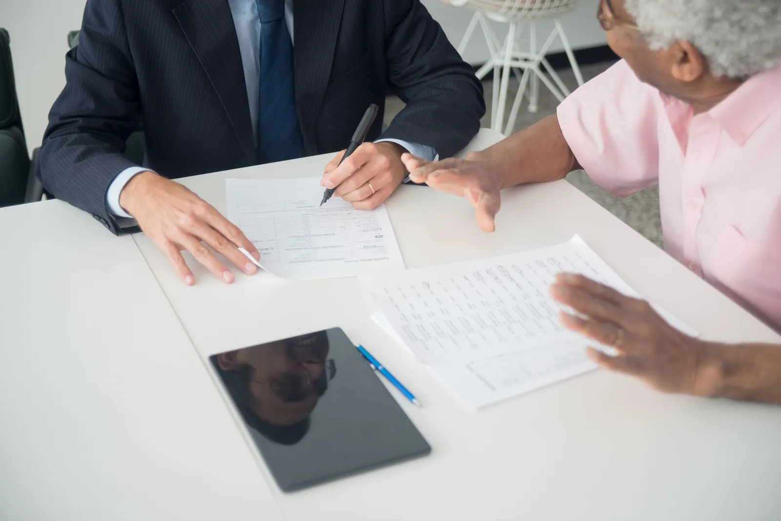 Two people going through a contract at a table
