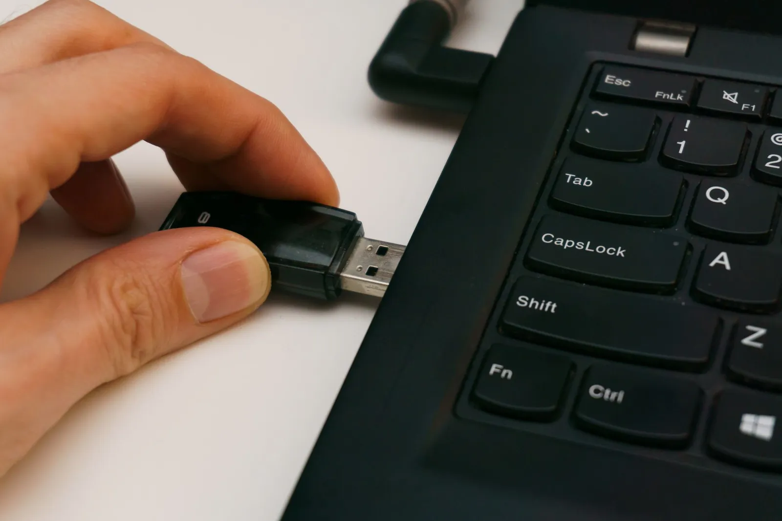 A person backing up files from a laptop to an external drive