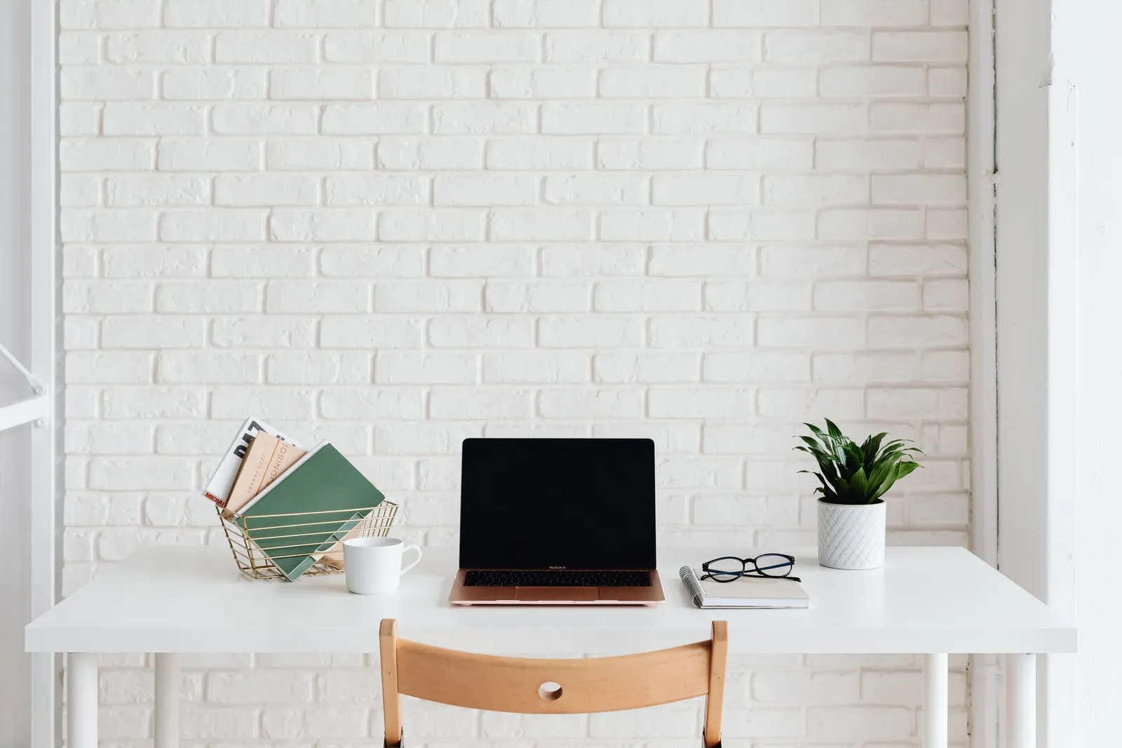 A tidy desk with a laptop showing a booking and agreement flow